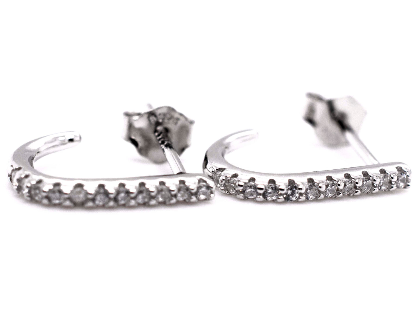 A pair of Super Silver Tiny Pave Cubic Zirconia Half Hoop Post Earrings with diamond-alternative stones.