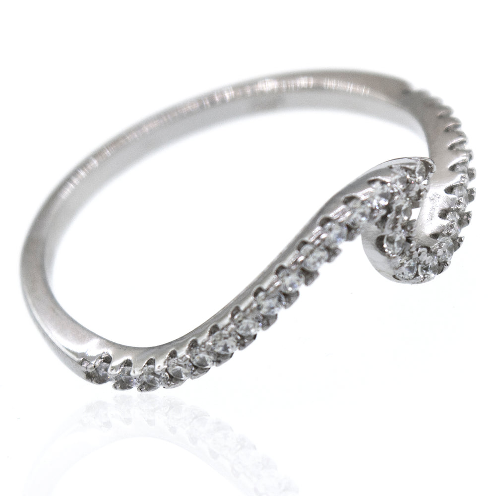 An elegant Pave Wave Ring with diamonds on it.