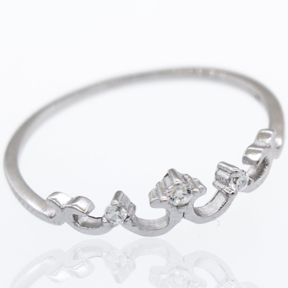 An elegant Crown Ring with Tiny Cubic Zirconia in white gold with diamonds on it.