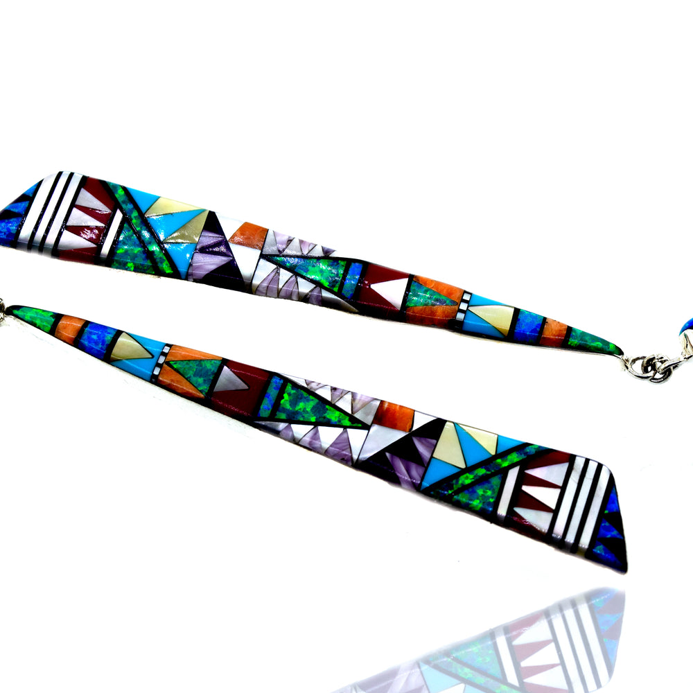 
                  
                    Super Silver's handcrafted Elongated Triangle Earrings with colorful geometric designs.
                  
                