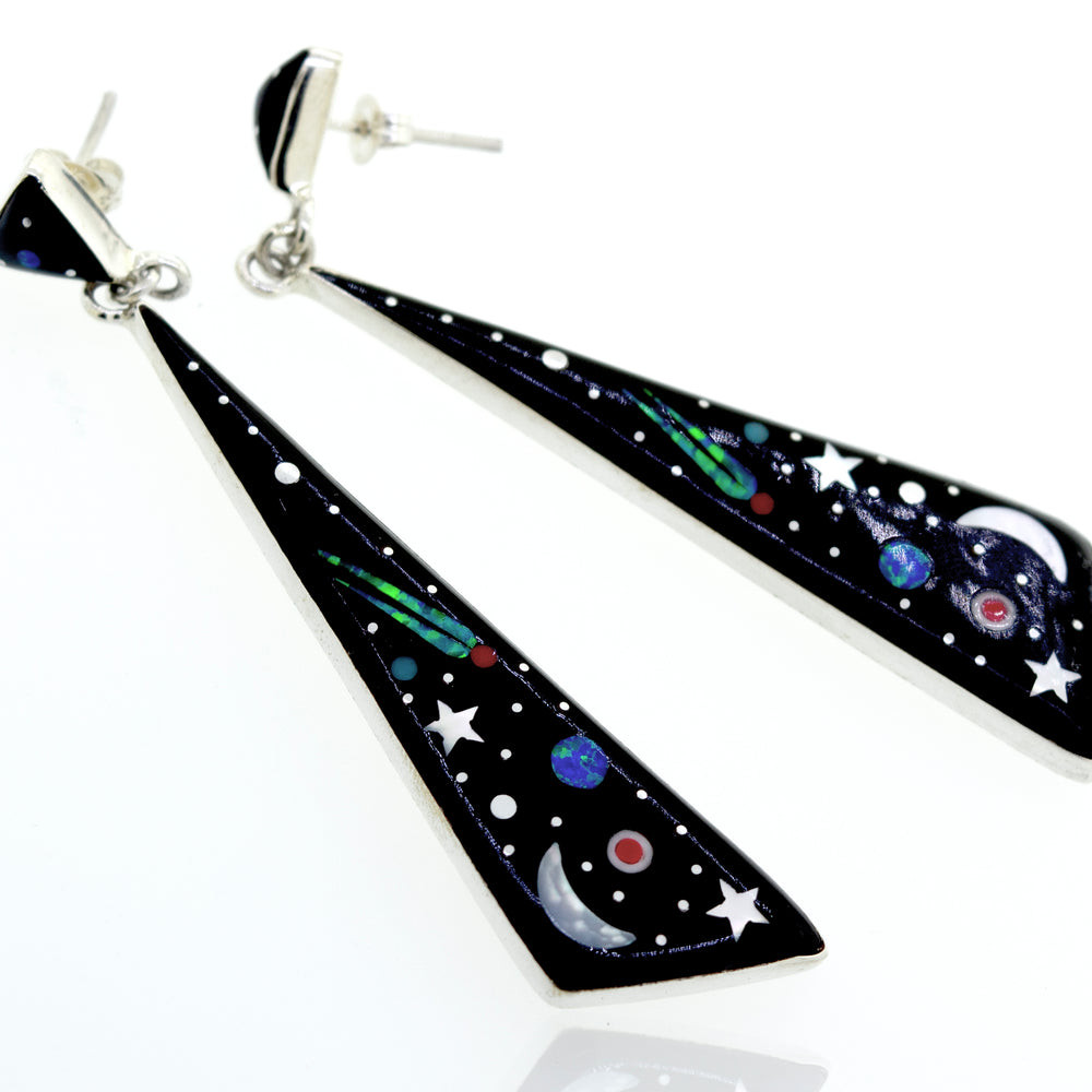 
                  
                    Super Silver's Handcrafted Outer Space Earrings adorned with stars and planets from the universe.
                  
                