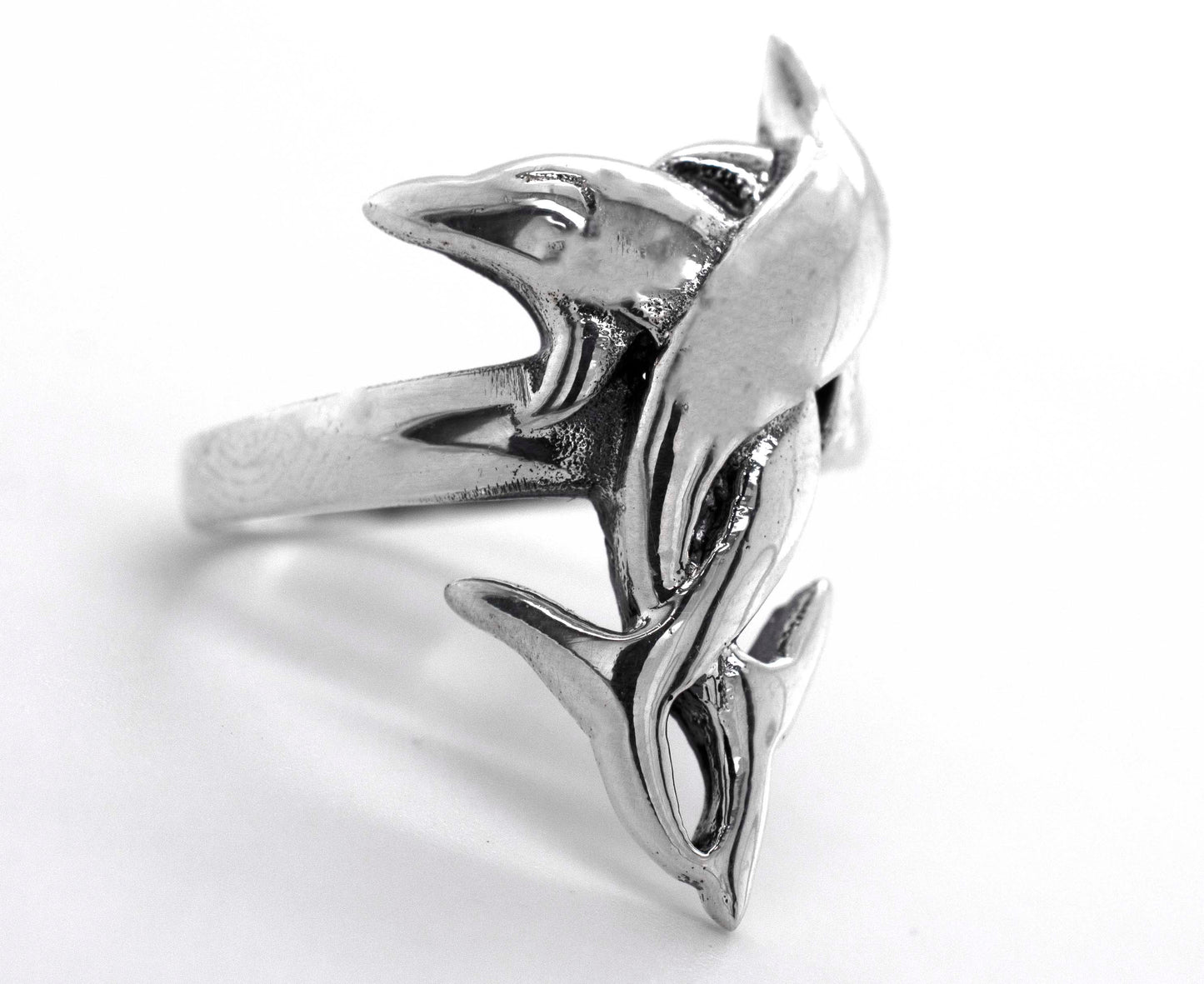 A sterling silver coiled dolphin ring.