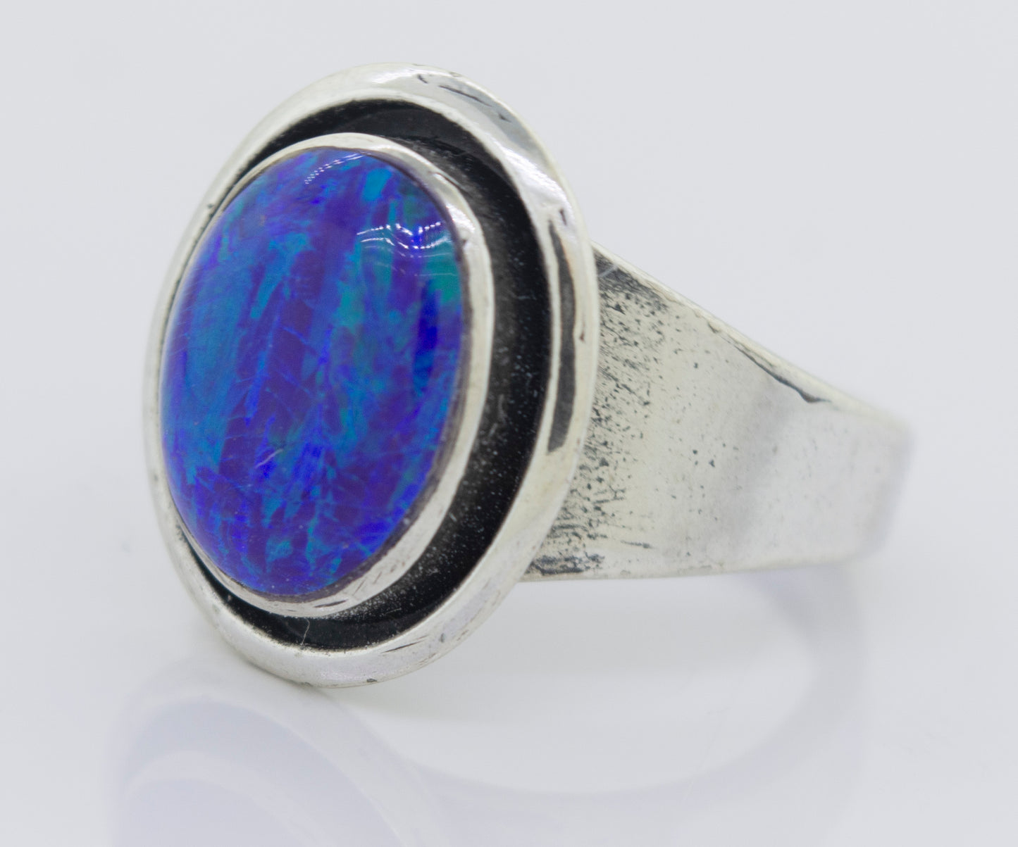 
                  
                    A minimalist silver ring with a Radiant Opal Signet Ring.
                  
                