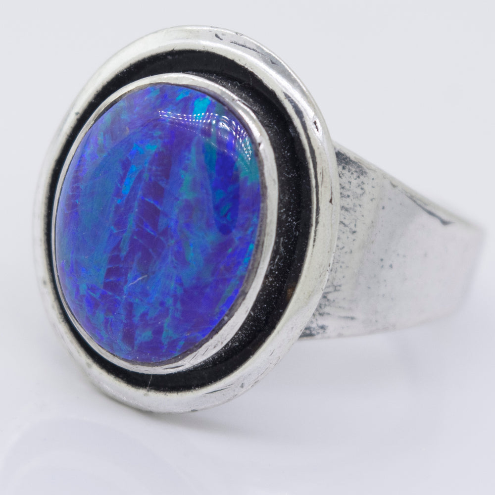 
                  
                    A Radiant Opal Signet Ring with a blue opal stone in the center.
                  
                