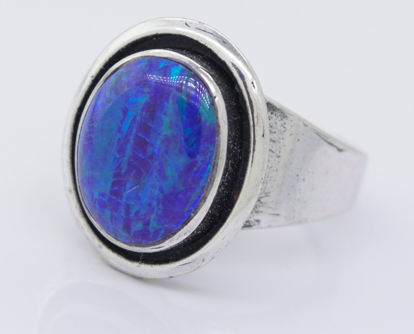 
                  
                    A Radiant Opal Signet Ring with a blue opal stone in the center.
                  
                
