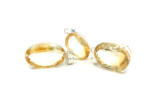 
                  
                    A pair of Brilliant Pronged Citrine Pendant earrings from Super Silver on a white background with a faceted cut.
                  
                