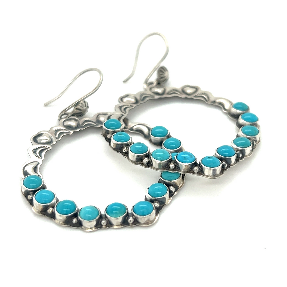 
                  
                    Super Silver's Statement Handmade Turquoise Earrings on a white background exude southwestern elegance.
                  
                