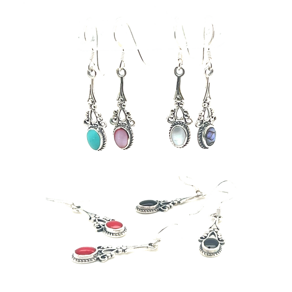 
                  
                    A pair of Super Silver Oval Shaped Inlaid Stone Earrings with Delicate Vintage Setting, perfect for achieving a boho look.
                  
                