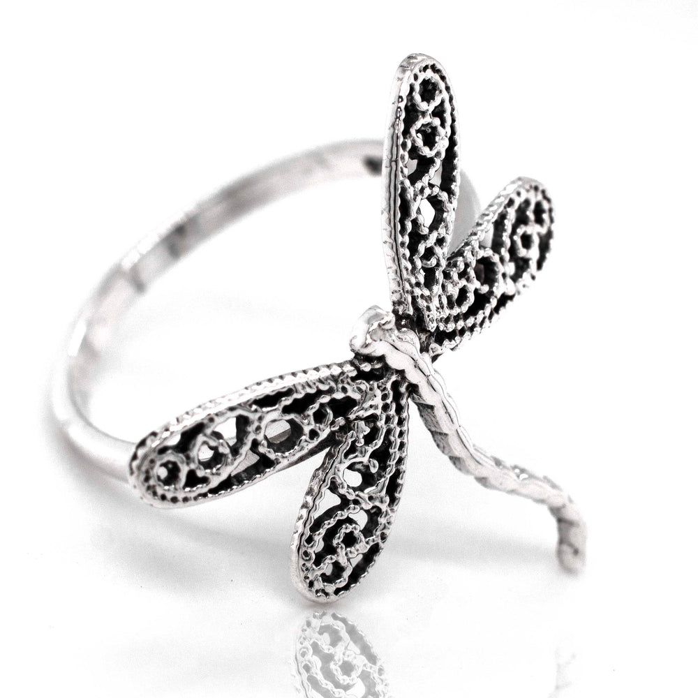 A boho-inspired Dragonfly Ring with Filigree Wings made of sterling silver, showcased on a pristine white background.