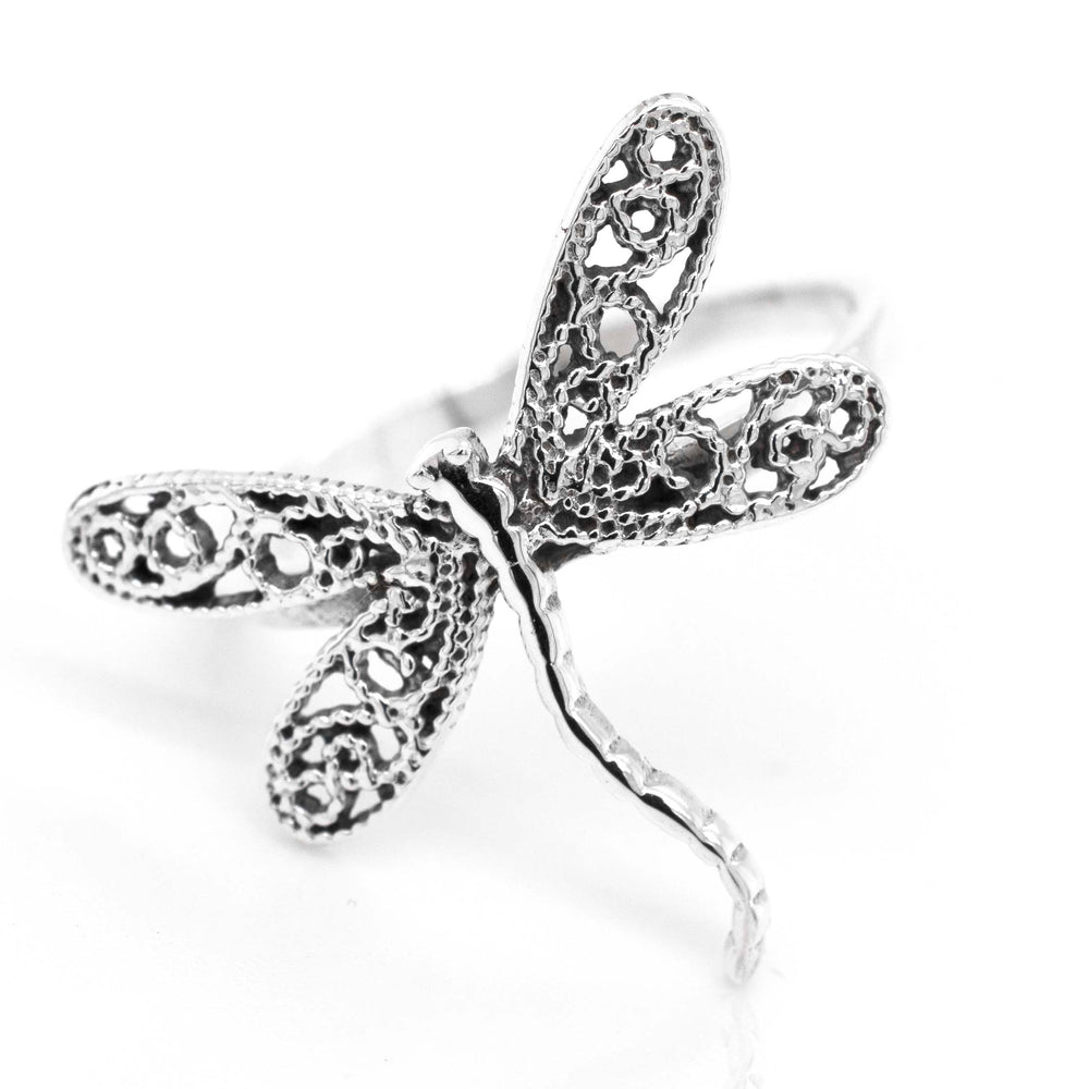 A Dragonfly Ring With Filigree Wings on a white background, exuding cottagecore vibes.