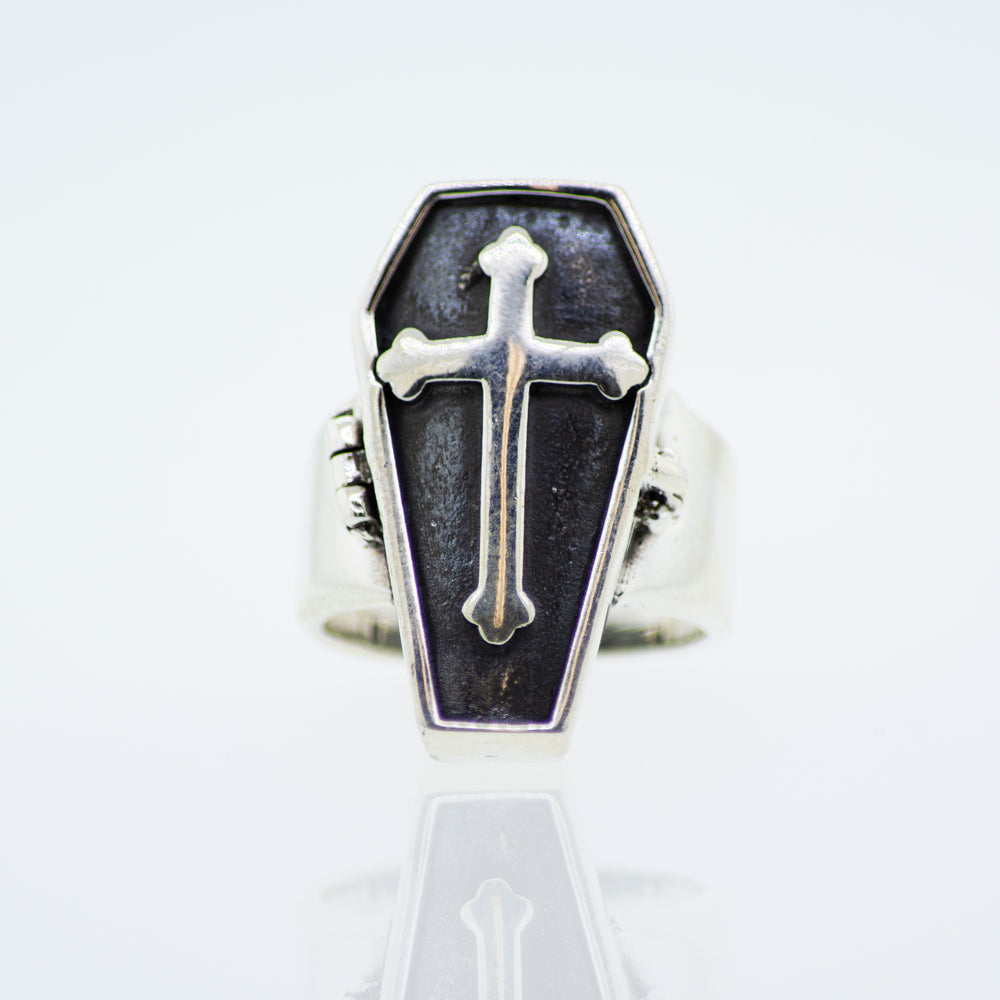 A silver Coffin Ring that Opens with a cross on it, perfect for Halloween or for men.