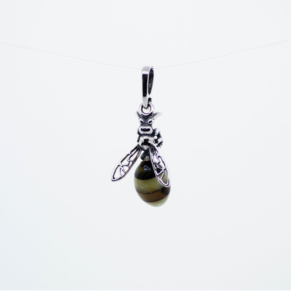 A Beautiful Amber Yellow Jacket Pendant with filigree wings, hanging from a string, made by Super Silver.