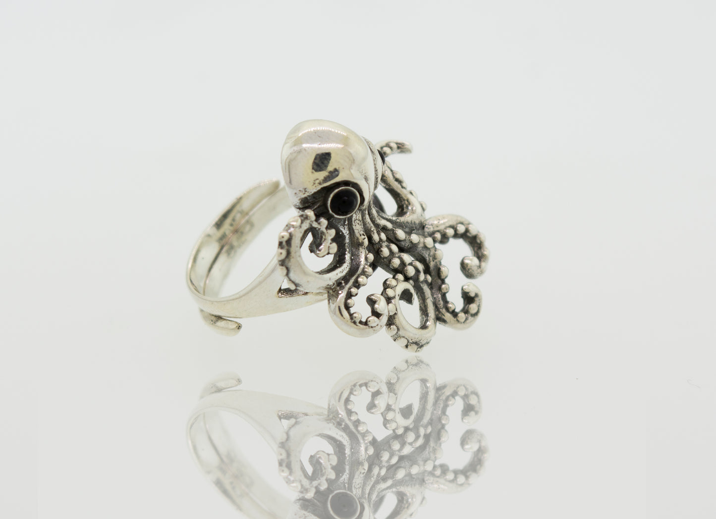A designer Octopus Adjustable Ring with sterling silver tentacles on a white background.