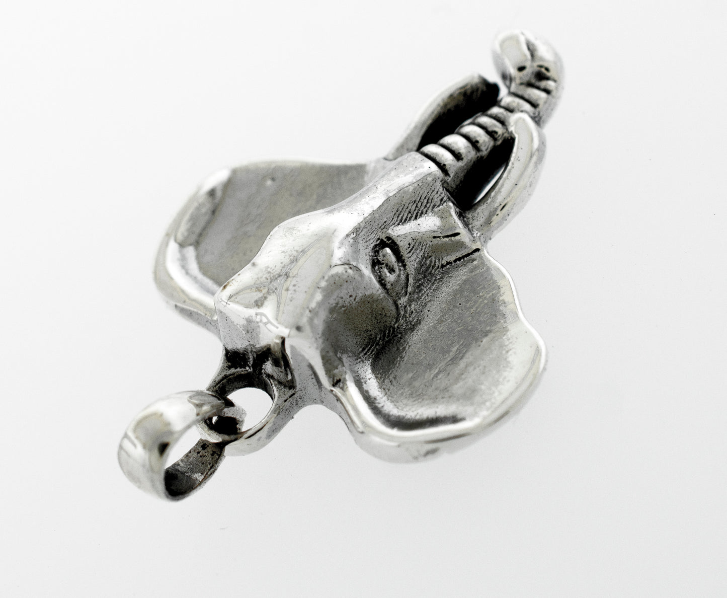 
                  
                    A Striking Elephant Head Pendant from Super Silver, gracefully placed on a pristine white surface.
                  
                