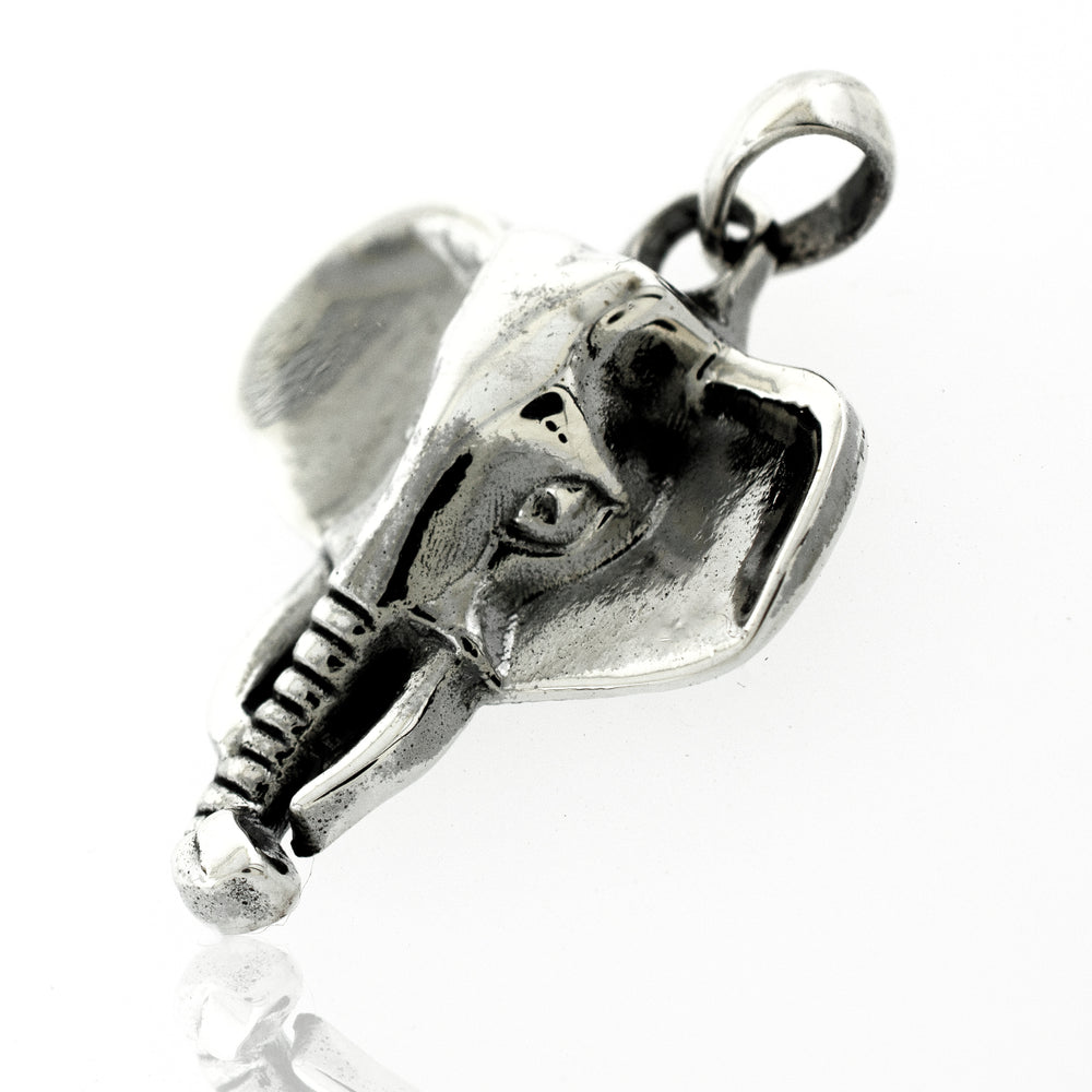 A Super Silver Striking Elephant Head Pendant on a white surface, representing symbolism.