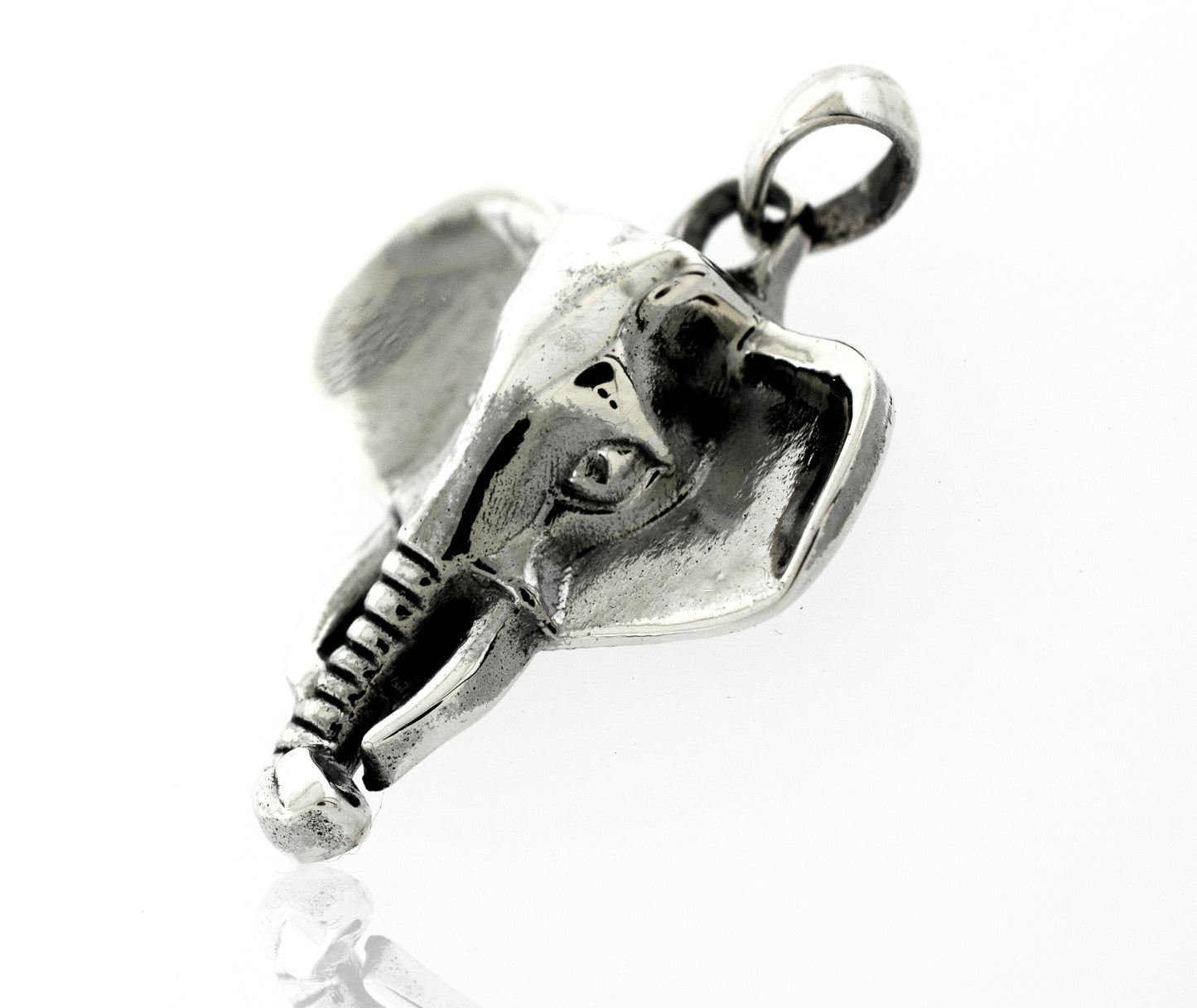 A Super Silver Striking Elephant Head Pendant on a white surface, representing symbolism.