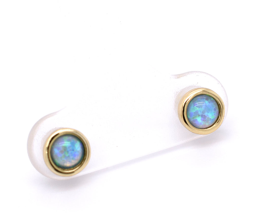 
                  
                    A pair of Super Silver Radiant Australian Opal Studs in brilliant blue on a white background.
                  
                