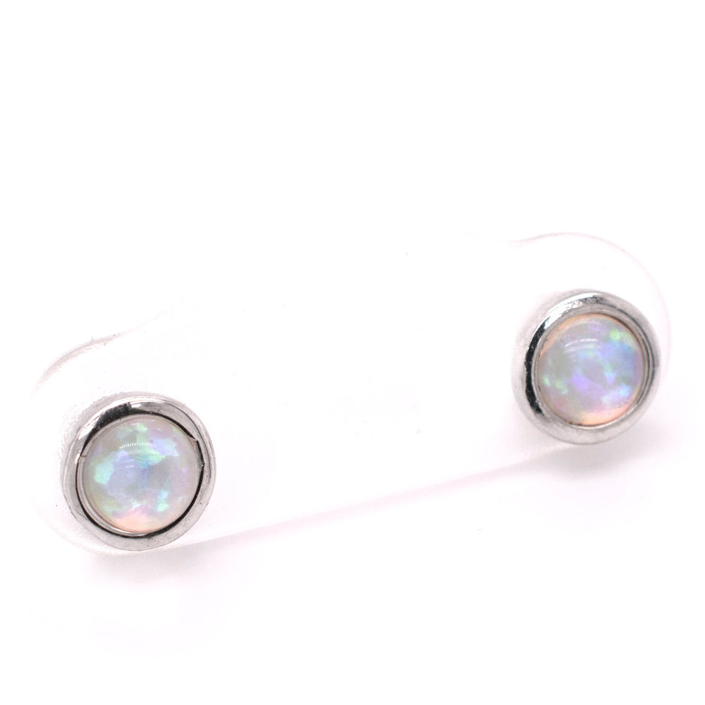 
                  
                    A pair of Radiant Australian Opal Studs from Super Silver showcasing brilliant colors on a white background.
                  
                