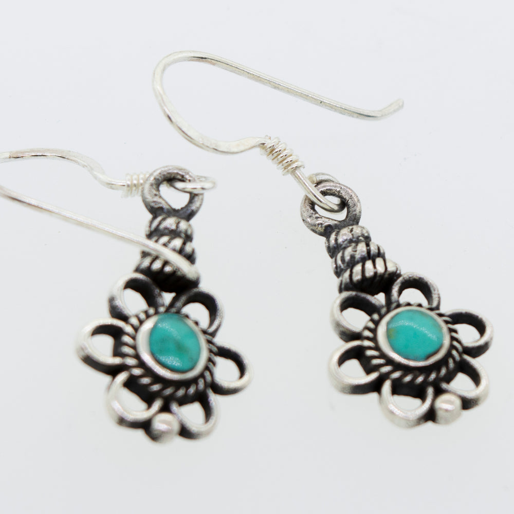 A pair of Flower Design Earrings with a Round Stone from Super Silver, made with sterling silver and round turquoise stones.