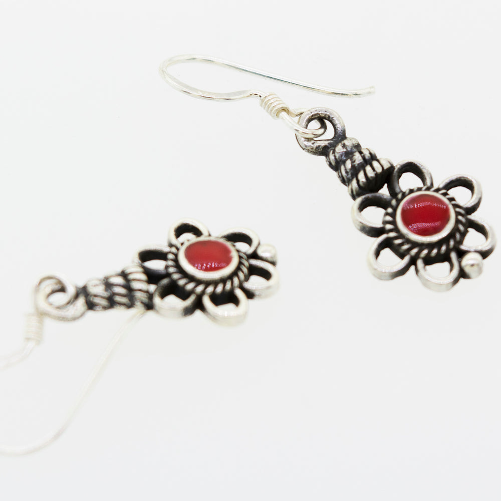 
                  
                    A pair of Super Silver Flower Design Earrings with a Round Stone and red coral stones.
                  
                