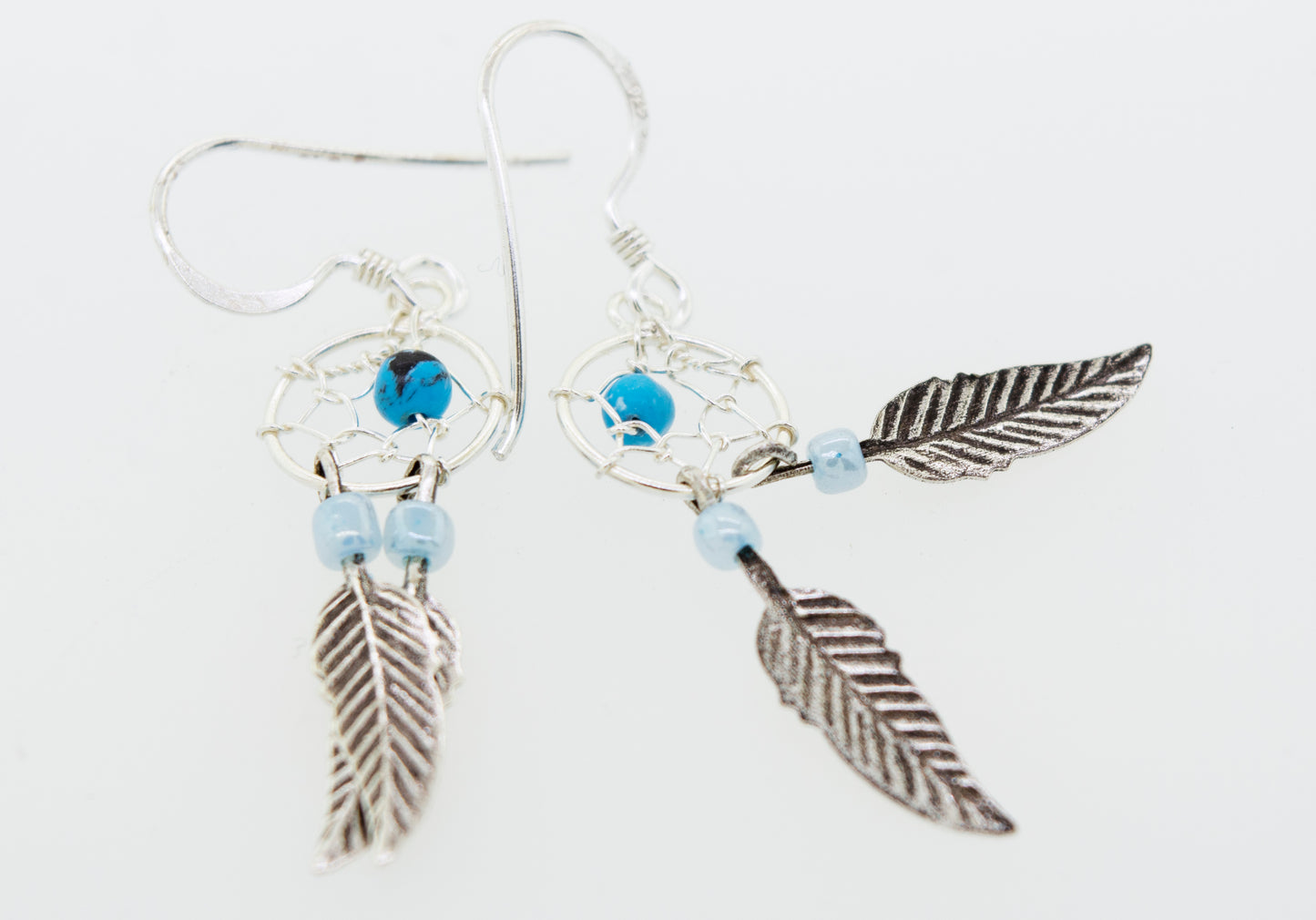 
                  
                    Lightweight Super Silver turquoise dreamcatcher earrings with blue turquoise nuggets.
                  
                