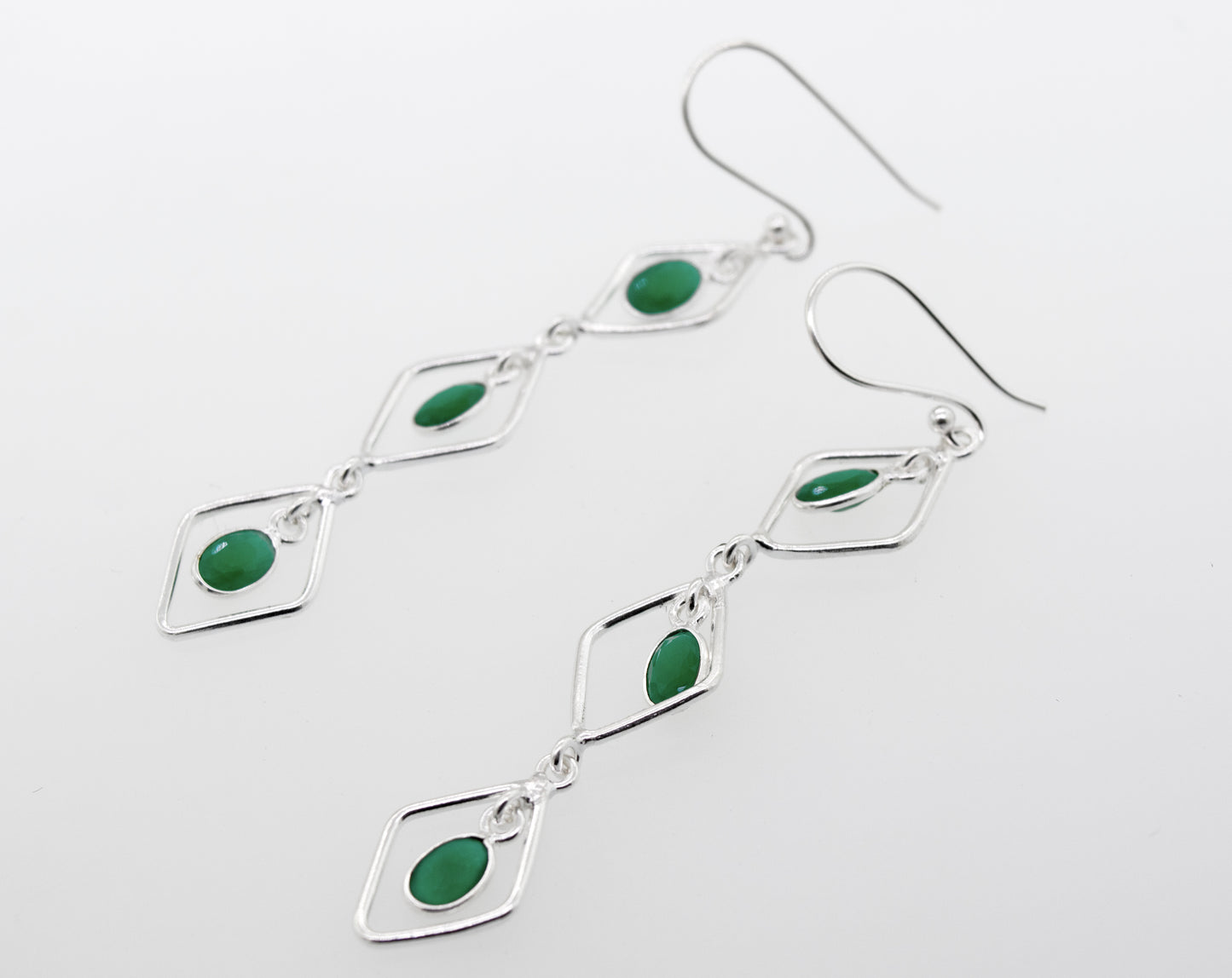 Super Silver's Wire Diamond Earrings with Emerald, measuring 2.5 inches long, are crafted in sterling silver.