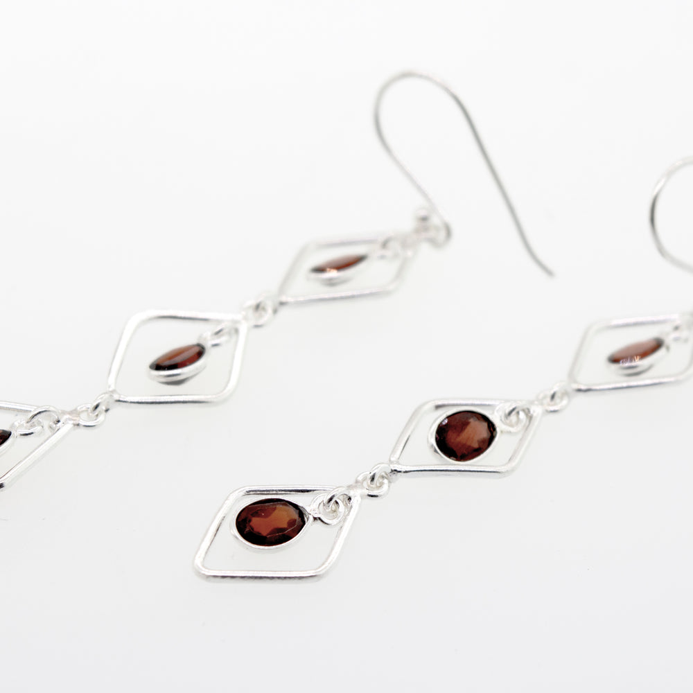 A pair of Super Silver Wire Diamond Earrings with Garnet stones, 2.5 inches long.