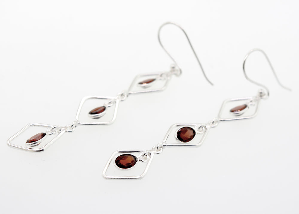 A pair of Super Silver Wire Diamond Earrings with Garnet stones, 2.5 inches long.