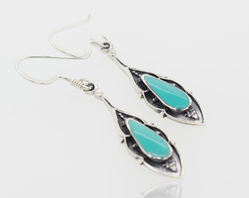 A pair of Super Silver Bali Inspired Turquoise Teardrop Earrings with green turquoise stones.