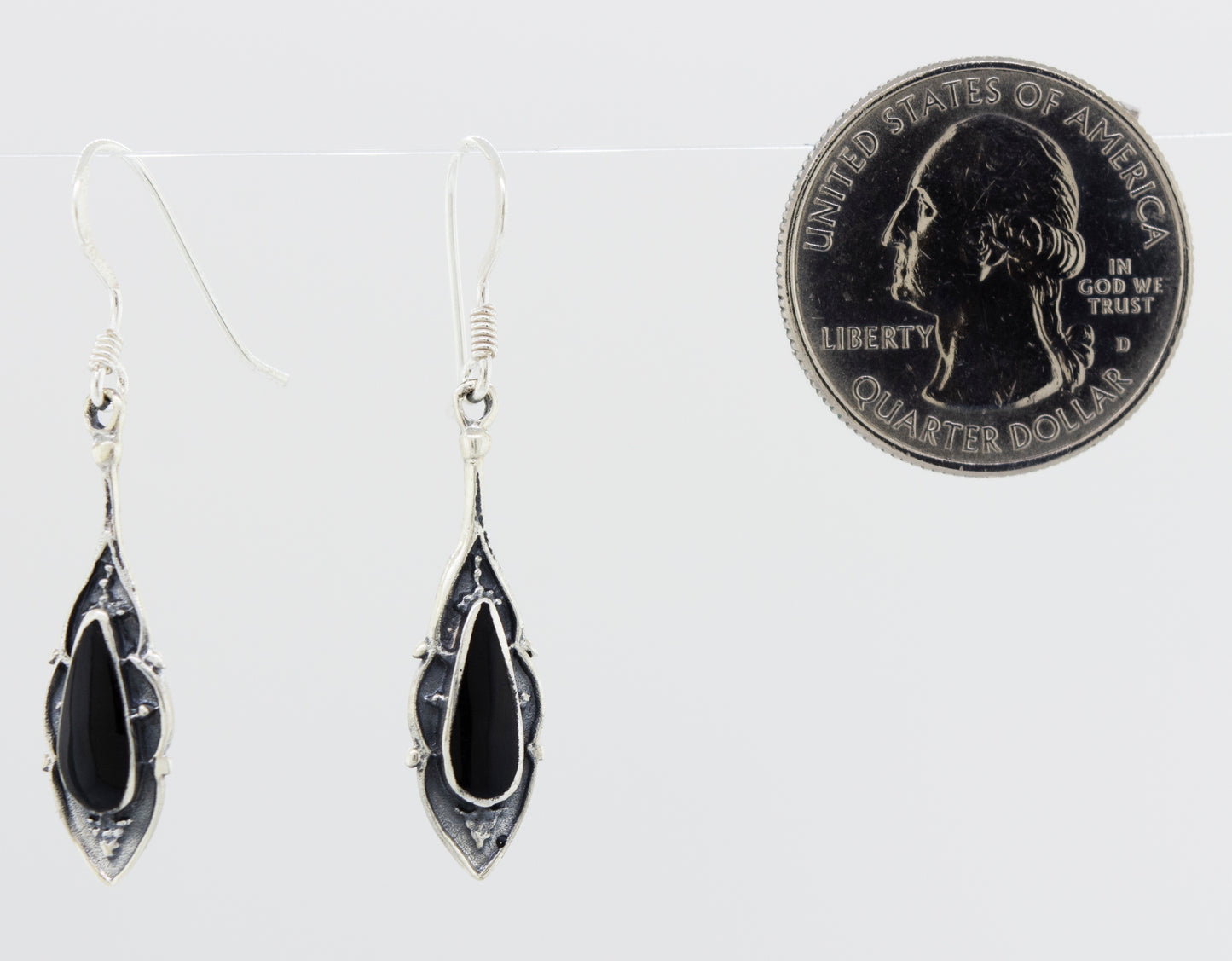 
                  
                    A pair of Super Silver Teardrop Shape White Mother Of Pearl Earrings next to a penny.
                  
                