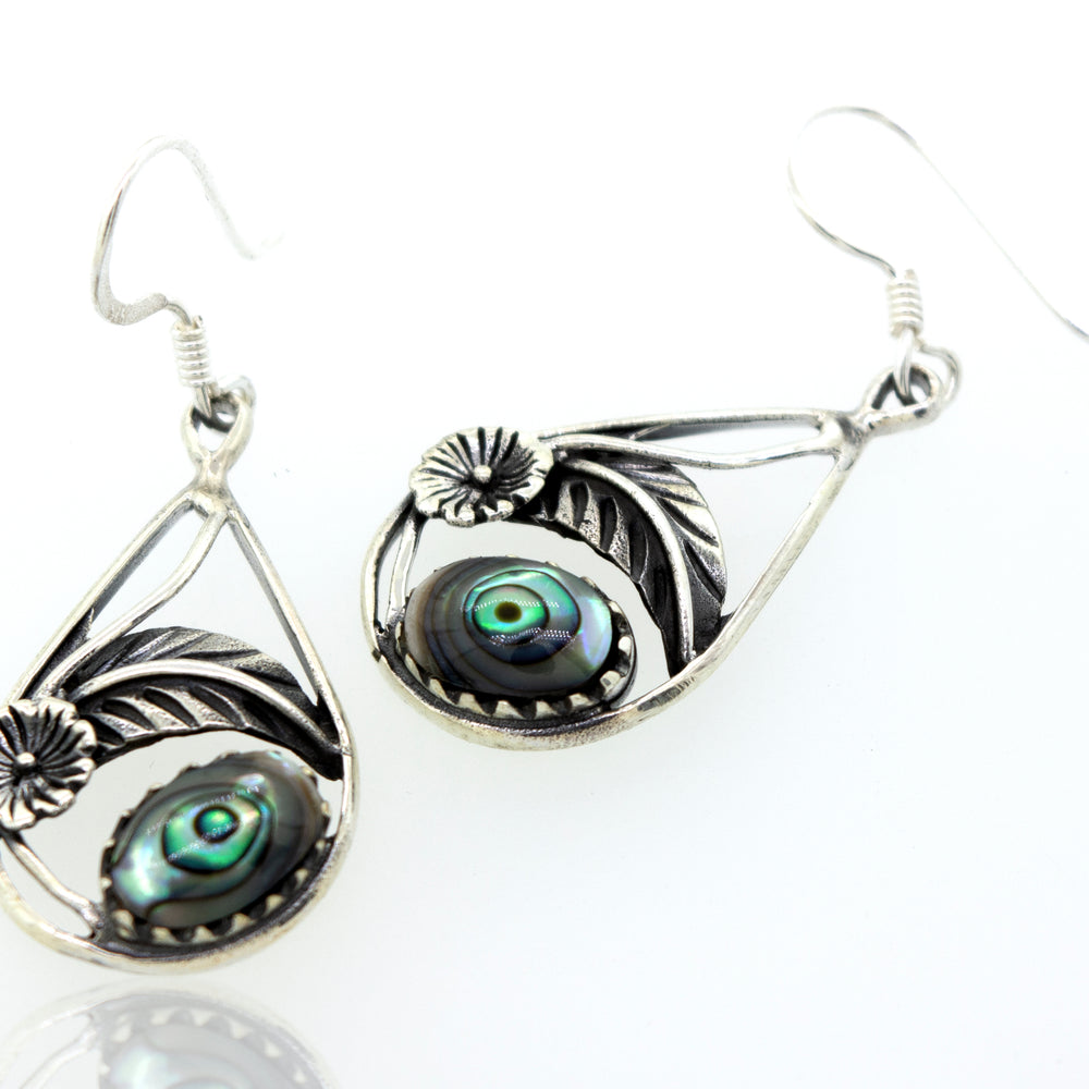 A pair of Super Silver Abalone Teardrop Earrings With Floral Setting.