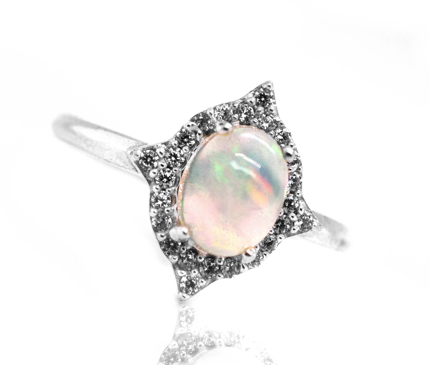 An Elegant Ethiopian Opal Ring With Cubic Zirconia Stones on a white background.