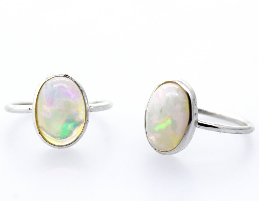 An elegant pair of Ethiopian Opal Ring with Oval Stone on a white background.