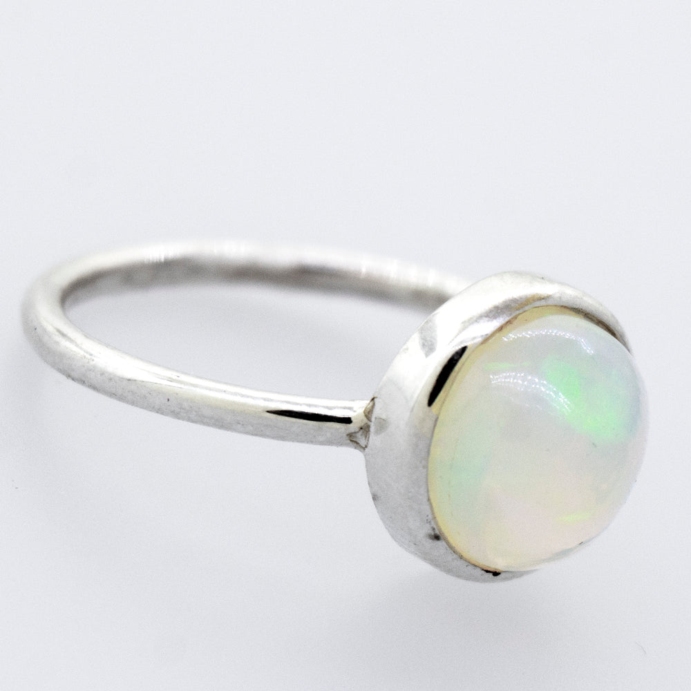 
                  
                    A stunning Round Ethiopian Opal Ring on a white surface.
                  
                