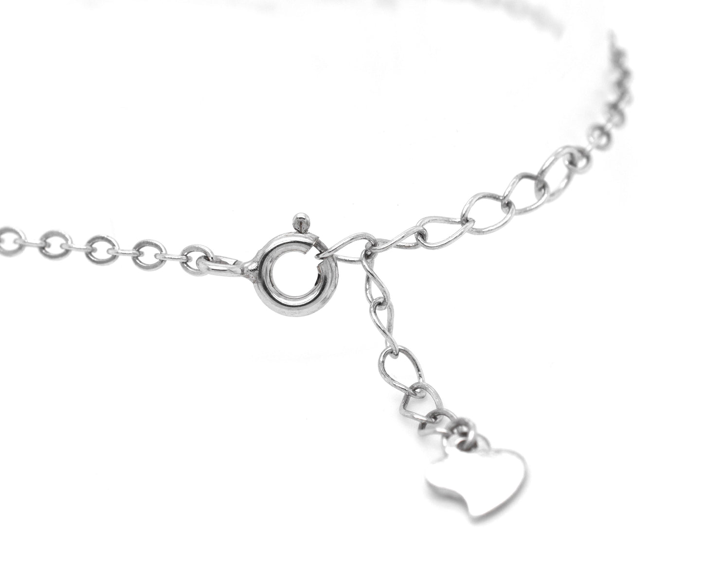 A minimalist Super Silver Protective Cubic Zirconia Evil Eye Bracelet with a heart charm.