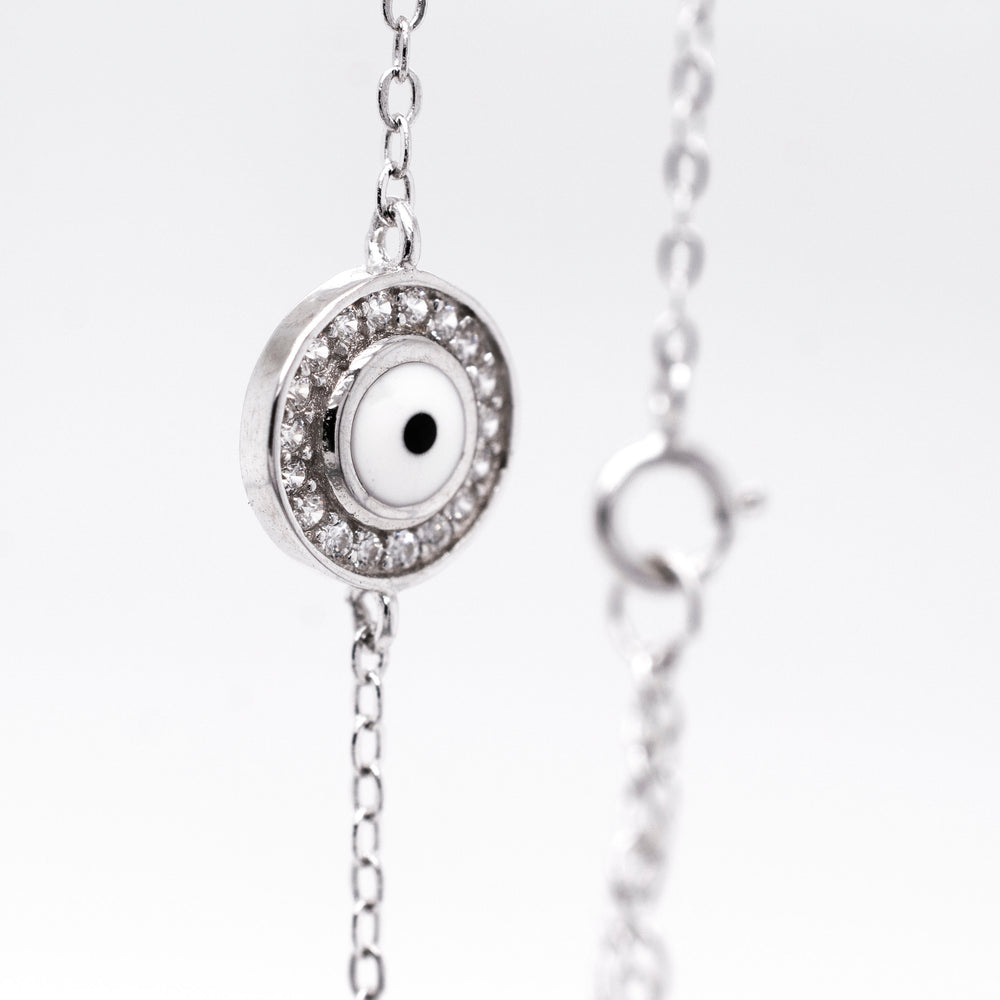 
                  
                    A minimalist protective cubic zirconia evil eye bracelet adorned with cubic zirconia.
                  
                