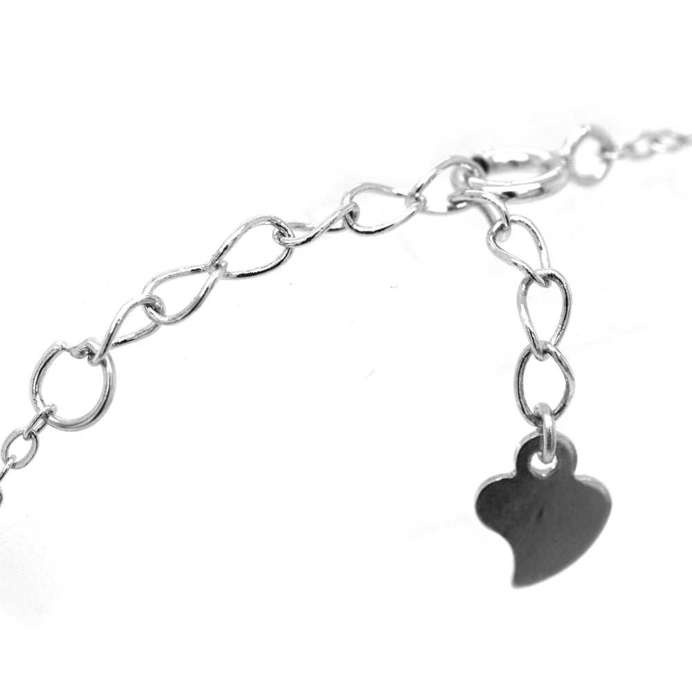 
                  
                    A Super Silver Classic Blue Pave Cubic Zirconia Evil Eye Bracelet with a heart charm attached to it.
                  
                