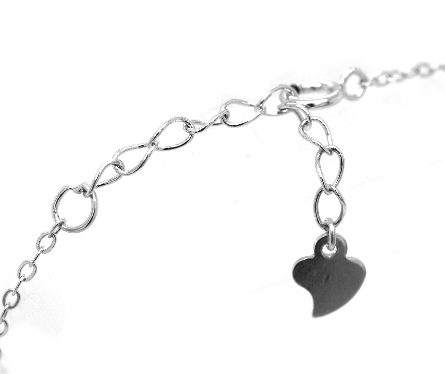 
                  
                    A Super Silver Classic Blue Pave Cubic Zirconia Evil Eye Bracelet with a heart charm attached to it.
                  
                