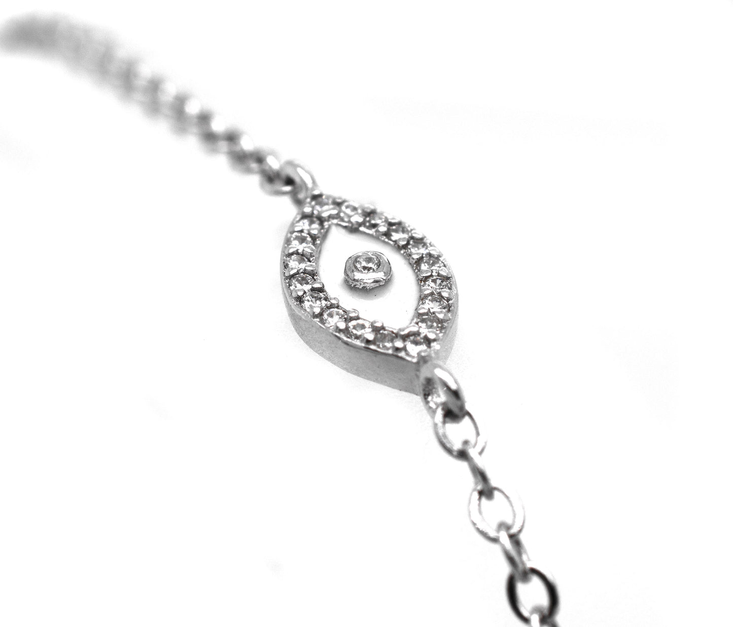 A Trendy Pave Cubic Zirconia Evil Eye Bracelet with a silver protective amulet adorned with cubic zirconia stones.