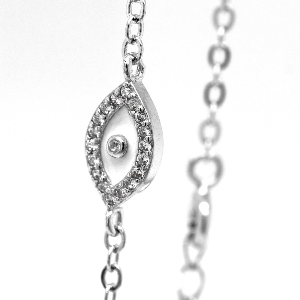 
                  
                    A silver chain with a protective Trendy Pave Cubic Zirconia Evil Eye Bracelet, encrusted with cubic zirconia stones, from Super Silver.
                  
                