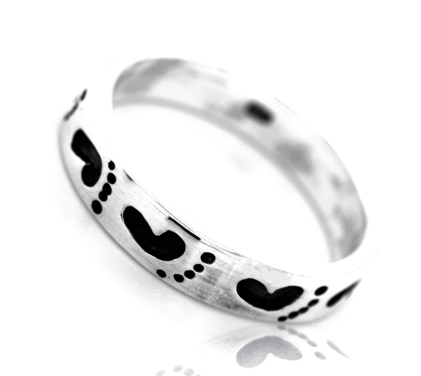 A Super Silver Footprint Band Ring with black hearts on it, perfect for the beach lover.