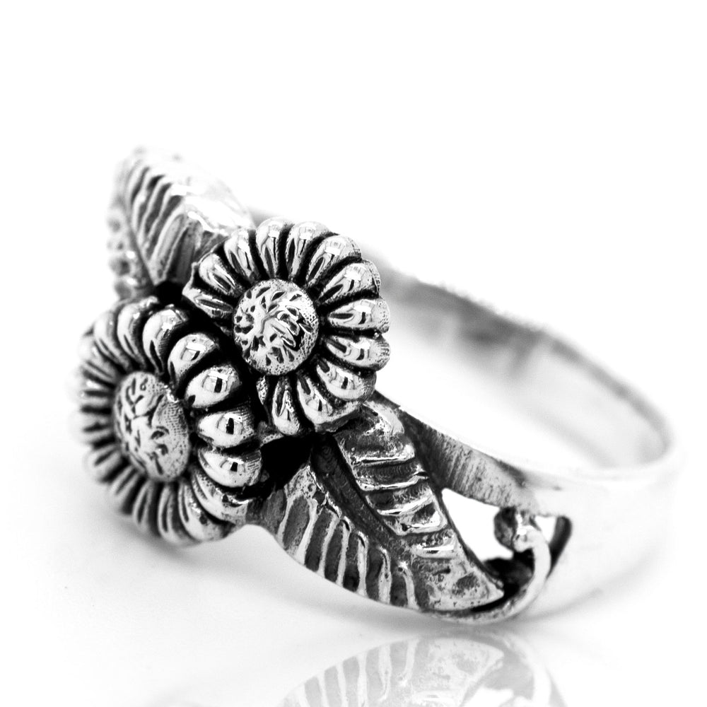 An Entwined Floral Ring, inspired by boho style and made of sterling silver, adorned with delicate floral designs.