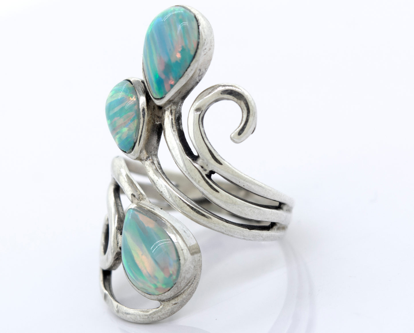 
                  
                    Handcrafted Super Silver Stunning Wrap-Around Opal Ring featuring a silver band with mesmerizing opal stone and elegant swirls.
                  
                