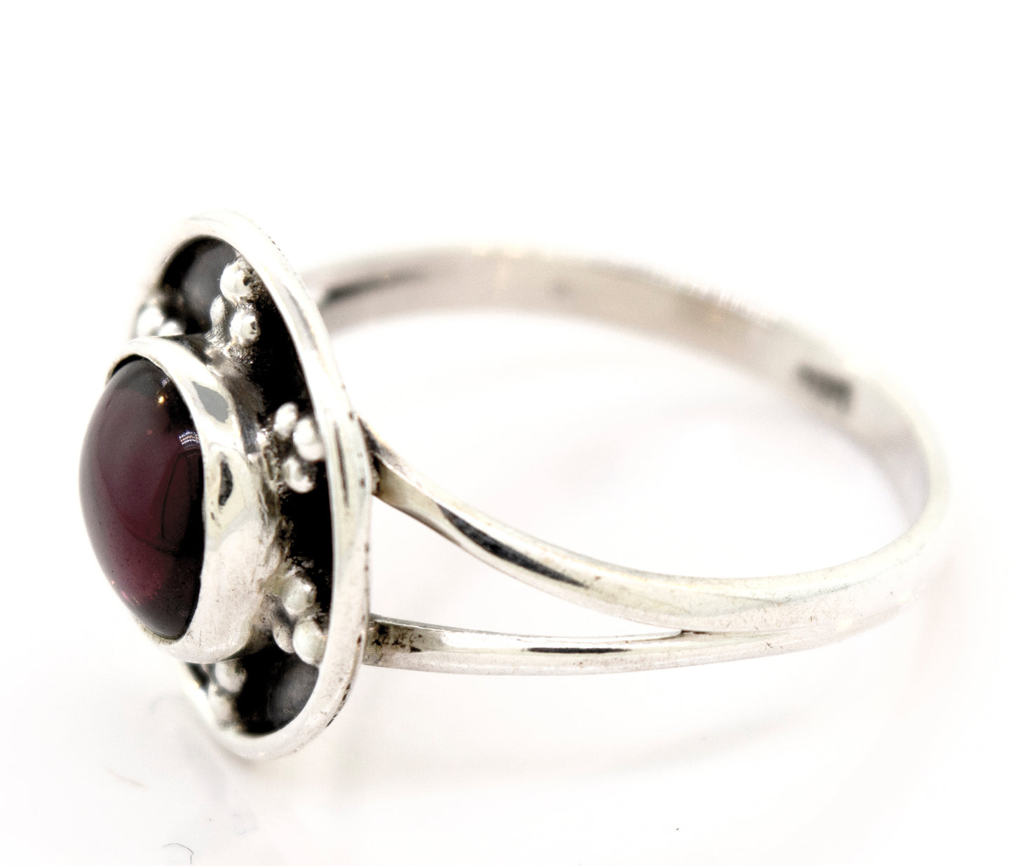 A Super Silver garnet ring with a unique oxidized silver design and a stunning garnet stone centerpiece.