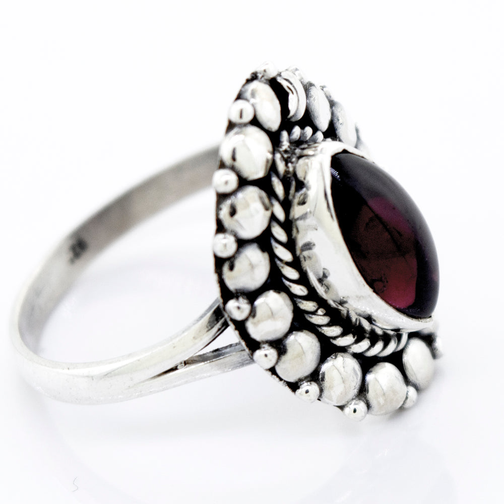 A Super Silver Marquise Shaped Vibrant Garnet Ring with a silver setting.
