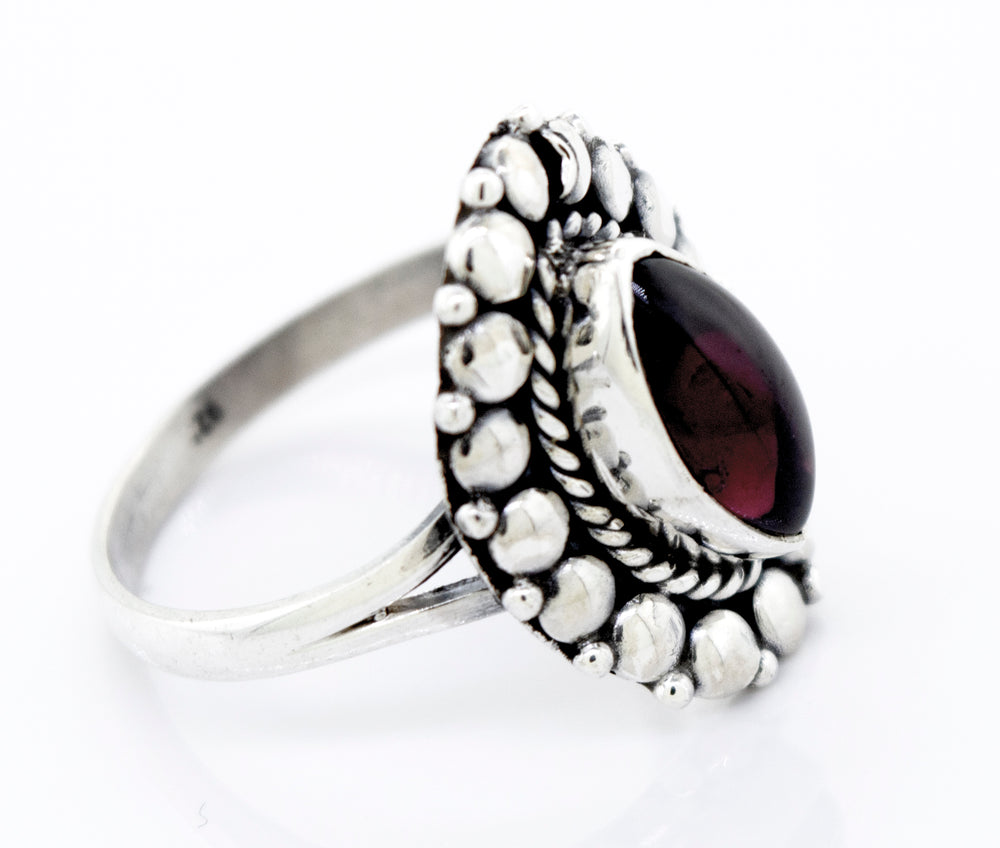 A Super Silver Marquise Shaped Vibrant Garnet Ring with a silver setting.