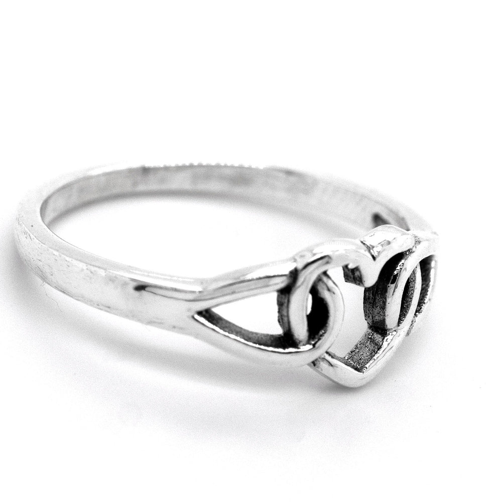A minimalist Love Knot Heart Ring, made of sterling silver and featuring a heart knot design at the center, symbolizes love.