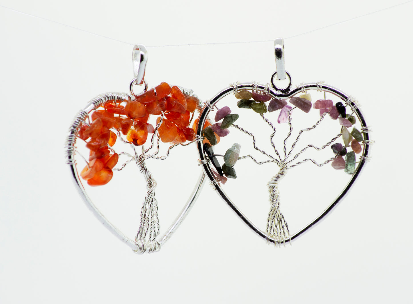 
                  
                    A Super Silver wire wrapped pendant featuring a Heart Shaped Tree of Life design, with two heart shapes on either side.
                  
                