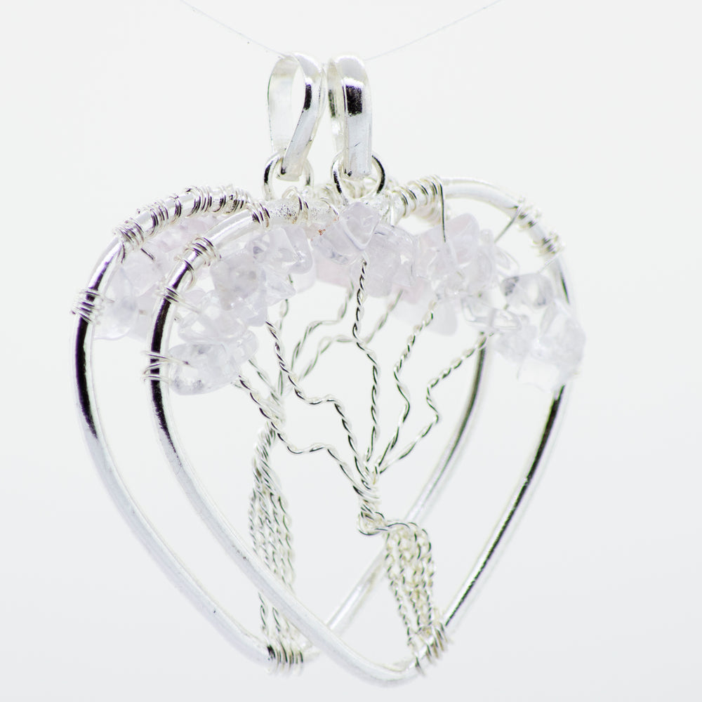 
                  
                    A wire wrapped Heart Shaped Tree of Life Pendant with a pink crystal in a silver Super Silver heart shape.
                  
                
