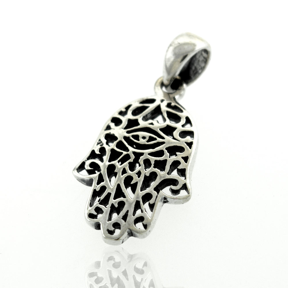 A Super Silver Hamsa Hand Pendant with a freestyle swirl design on a white surface.